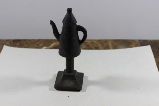 A Solid Metal Teapot on Stand