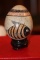 Carved Stone Egg on Woodstand