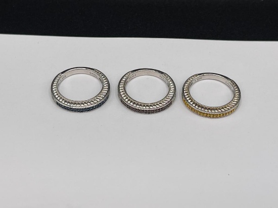SET OF THREE STERLING SILVER RINGS FEATURING BLUE, YELLOW, AND RED ROUND CUT STONES