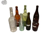SEVEN ASSORTED ANTIQUE AND VINTAGE BOTTLES FOUR HAVE EMBOSSED LETTERING AMER PICON, BUFFALO BREWING