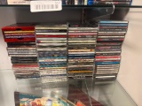 NEARLY 100 ASSORTED MUSICAL CD'S INCLUDING ZZ TOPS GREATEST HITS, AEROSMITH, WHITNEY HOUSTON, ETC.