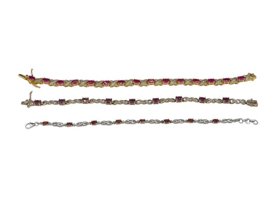 THREE STERLING SILVER RED STONE TENNIS BRACELETS