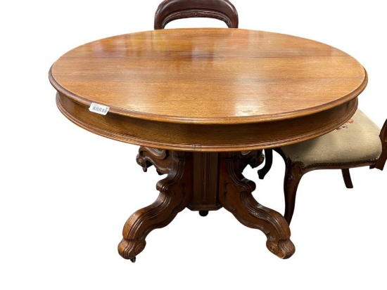ANTIQUE SOLID OAK DINING TABLE WITH ELABORATE DUAL LEG BASE