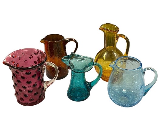 FIVE HAND BLOWN ART GLASS SMALL PITCHERS IN VARIOUS COLORS AND STYLES, RUFFLED RIM, CRACKLED GLASS