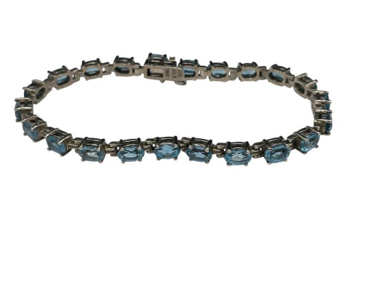 STERLING SILVER OVAL CUT BLUE TOPAZ TENNIS BRACELET