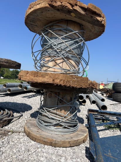 2 wooden wire spools with some wire