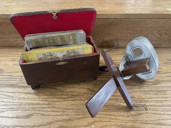antique stereoscope viewer with a collection of stereoscopic cards.