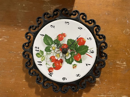 vintage wall clock featuring a decorative strawberry and floral motif on its face.