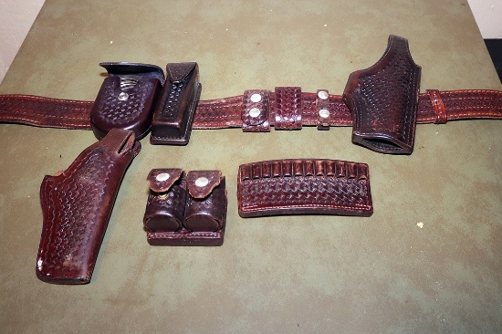 Leather gun belt with holster and accessory holders; includes cuff case and handcuffs