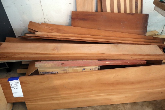 All lumber stacked on floor against wall