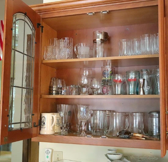 Contents of bar in living room: glassware, stemware, cd's, and dvd's