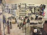 TOOLS HANGING ON WALL, INCLUDES WRENCHES, SOCKETS, EXTENSIONS, BOLT CUTTERS, RATCHETING COME ALONG