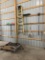 ASSORTED HAND TOOLS INCLUDING RAKES, SHOVELS, BROOMS AND A FIBERGLASS LADDE