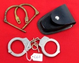 Smith & Wesson handcuffs in holder for belt; some type of restraint marked Whiteaway – Laidlaw & Co.