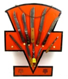 KK; logo shaped board with 10 KK; knives