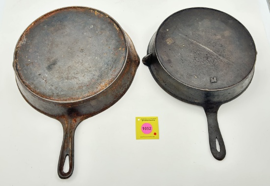 Skillets: Lot of 2: Unmarked 10 skillet w/ heat ring (1). Unmarked raised 8 skillet w/ raised M on b