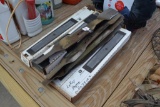 Several used lawn mower blades