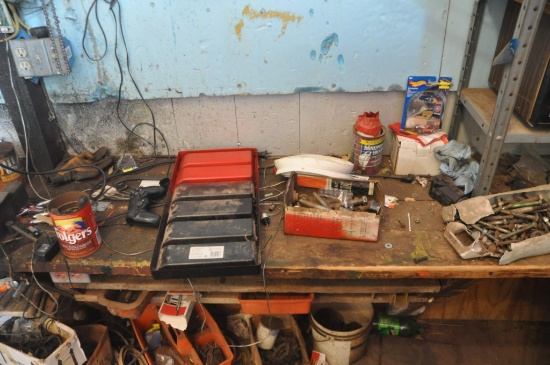 Contents on and under work bench, work bench stays with property