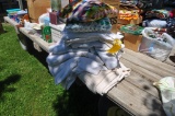 assortment of blankets and dry goods