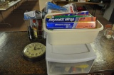 kitchen utensils, clock, and cleaning supplies