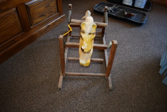 plastic rocking horse on wooden base