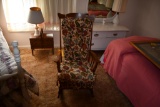 wooden rocking chair with floral print cushion