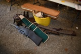 tub with boots size 13, camo cooler, hunting bag, and gun cases