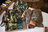 flat of camo stalking caps, face mask, insulated gloves, and camo bags
