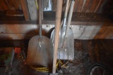 Group of long handle tools including scoop shovel, pitch fork, and paint scraper