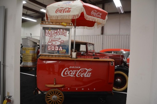 Restored metal embossed Coca-Cola cooler and popcorn machine on rolling cart