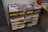 bookshelf full of classic car magazines and automobilia