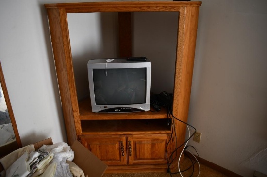 Corner entertainment center with older box style TV