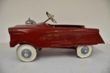 Red pedal car with bell appears complete