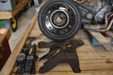2000 Pontiac Trans Am spare tire with bracket and tire tools,