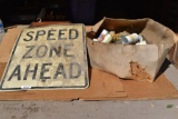 Speed zone ahead sign & box of vintage beer cans