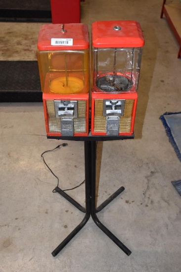 (2) Vintage Northwestern coin operated candy machines on stand (1 is glass the other is plastic)