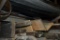 3-Shelves of scrap lumber, older fuel tanks, 5 gal. buckets, old step ladder, etc. near west wall of