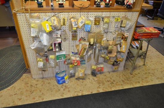 Items on peg board: mainly faucet parts