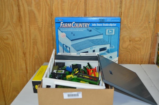 Flat of John Deere tractors and farm related toys