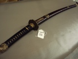 JAPANESE SAMURAI SWORD, SIGNED BY FORGER UNDER HANDLE ON HAND GUARD WITH WOODEN SHEATH.  CARVING ON