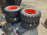 Four Unused 12-16.5 Skid Steer Tires on Bobcat Wheels