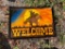 Welcome sign with Cowboy backdrop