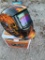 Auto welding helmet with flaming skull design