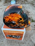 Auto welding helmet with flaming skull design