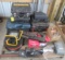 Contents of pallet including work light, extension cord, empty tool cases,