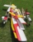 Assortment of RC airplanes and parts.