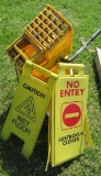Rubbermaid mop bucket and caution signs.