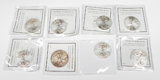 EIGHT (8) UNCIRCULATED SILVER EAGLES - (2) 2014, (6) 2015