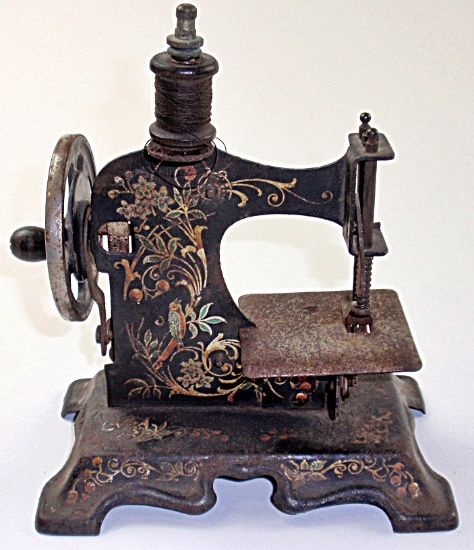 A 19th C Pressed Steel Toy Sewing Machine w/gilt scrollwork, G+ working con