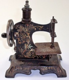 A 19th C Pressed Steel Toy Sewing Machine w/gilt scrollwork, G+ working con